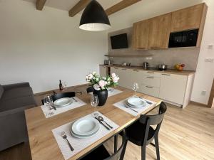 a kitchen and dining room with a table and chairs at Apartmány Lošov in Olomouc
