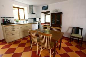 a kitchen with a wooden table and chairs in it at LA MAISONNETTE DU POTIER in Caunes-Minervois +16 photos