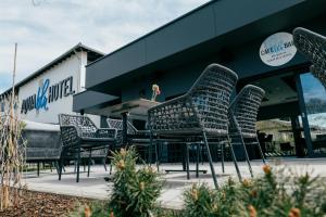 a group of chairs sitting outside of a building at Aqua Blu Hotel in Bad Füssing