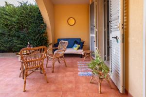 a patio with chairs and a couch and a table at Casa Saracena in Melendugno +14 photos