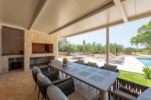a dining room with a table and chairs and a fireplace at Villa New Life Zadar in Sukošan