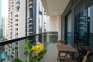 a balcony with a table and chairs and buildings at INA Homes - Act 1 Full Burj Khalifa and Fountain Views in Dubai