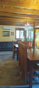 a dining room with wooden tables and chairs at Refugio La Presa in Chulilla