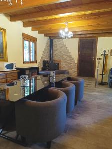 a row of chairs in a room with wooden ceilings at Refugio La Presa in Chulilla