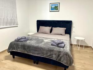 a bedroom with a bed with two towels on it at Apartment with private pool Mukalba in Medulin