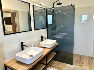 a white bathroom with two sinks and a shower at Apartment with private pool Mukalba in Medulin +13 photos