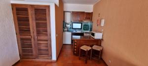 a kitchen with a counter and a kitchen with a sink at Albufeira Jardim by Umbral in Albufeira