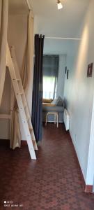 a room with a staircase and a couch in a room at appartement T1bis St Lary soulan village in Saint-Lary-Soulan
