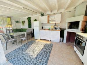 a kitchen with a table and a refrigerator and a table at House Varna-3 in Krapets