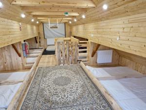 a large wooden room with several beds in it at Cowboy's Land in Višnja Gora