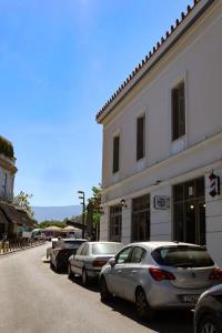 a row of cars parked in front of a building at Thiseas Luxury Apartment in Athens