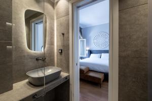 a bathroom with a sink and a mirror at Thiseas Luxury Apartment in Athens