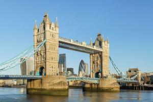 a bridge over the water with a city in the background at Large Duplex in Bermondsey in London