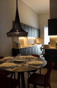 a kitchen with a table with plates and wine glasses at Thiseas Luxury Apartment in Athens