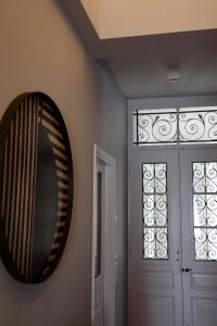a mirror hanging on a wall next to a door at Thiseas Luxury Apartment in Athens