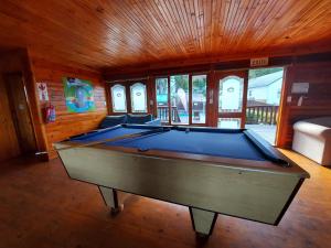 a room with a pool table in a house at First Group Knysna River Club in Knysna
