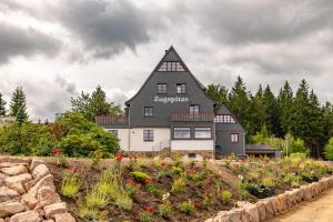 a large black and white house with a roof at Chalet Zugspitze in Kurort Altenberg