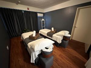 a hospital room with three beds and a window at Paradiso Resort & Spa in Saipan