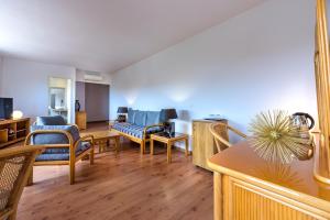 a living room with a couch and chairs at Hotel Le Tilbury in Porto-Vecchio