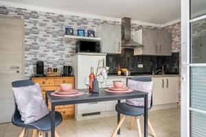 a kitchen with a table and two chairs at Ferienwohnung For two in Mahlberg