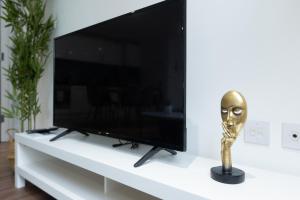 a trophy sitting on a white table next to a television at Imperial liverpool street apartments in London