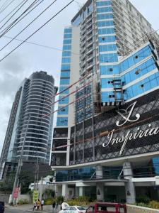 un gran edificio con un cartel delante en Loft Unit One Bedroom with terrace, en Davao City