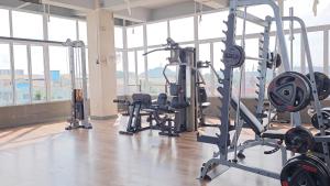 a gym with several treadmills and exercise bikes at Grand Sydney Hotel in Batam Center
