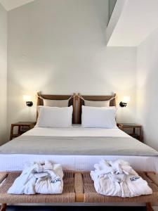 a bedroom with a bed with towels on it at La Mer Luxury Apartments in Ierissos