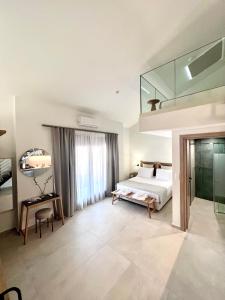 ein Schlafzimmer mit einem Bett und einer Glaswand in der Unterkunft La Mer Luxury Apartments Ierissos in Ierissós