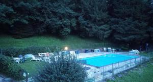 an overhead view of a swimming pool at night at Lake Apartment Ischia White, Lago di Caldonazzo in Tenna 