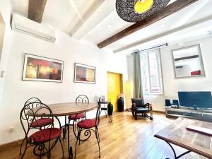 a dining room with a table and chairs at ApartHotel Riviera - Nice Côte d'Azur - Old Town - Promenade des Anglais in Nice