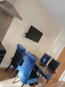 a dining room with a table and chairs with a tv at Tara View Apartments in Garristown