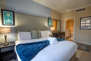 a bedroom with a large bed with towels on it at Stay at The Point - Exclusive Executives Escape in Durban