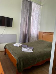ein Schlafzimmer mit einem Bett mit Handtüchern darauf in der Unterkunft Арт-готель "Династія" in Bila Zerkwa