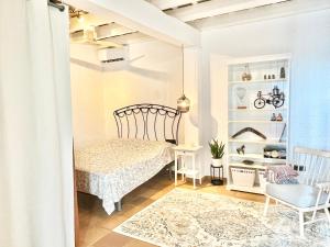 a bedroom with a bed and a chair at Villa Only Adults 2 Pax · Piscina Privada · A/C · WIFI · BBQ in Blanes