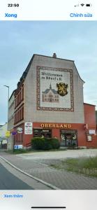 a building with a sign on the side of it at Ferienwohnung Goldener Drache in Adorf
