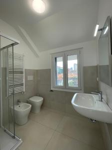 a bathroom with a sink and a toilet and a window at Carissimi 4 in Milan +18 photos