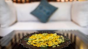 a plate of flowers on a table with a star at Lynnaya Urban River Resort in Siem Reap
