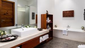 a bathroom with two sinks and a large mirror at Lynnaya Urban River Resort in Siem Reap