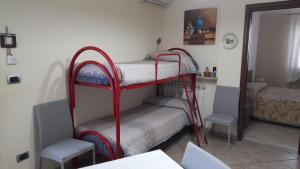 a room with two bunk beds and a mirror at B&B Villa Rosalia in Barrafranca