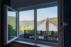 a room with a window with a view of the mountains at Ferienwohnung Auf Sarret in Bullay