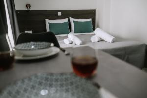 a glass of wine sitting on a table next to a bed at Crystal Studios in Ierissos