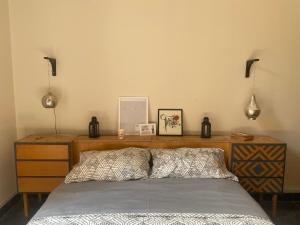 a bedroom with a bed and a wooden dresser at Homestay in Cairo