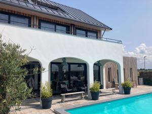 a house with a swimming pool next to a building at Villa Zandvoort in Zandvoort