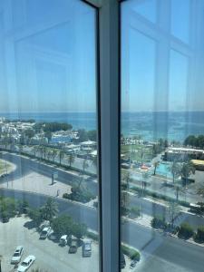 a window in a building with a view of a parking lot at Gulf grand hotelجلف جراند اوتيل in Kuwait
