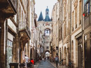 an alley in the city with people walking down it at Premiere Classe Bordeaux Sud Pessac Bersol in Pessac