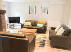 a living room with two couches and a tv at Old Court Terryglass 4 Bed No 12 in Terryglass