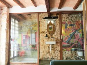 a room with a wall with a painting on it at Cal Jueu. Casa original. in Tarragona +45 photos
