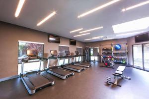 a gym with a row of treadmills and machines at Hampton Inn & Suites Seattle-Downtown in Seattle