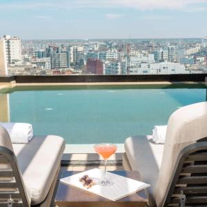 卡薩布蘭卡的住宿－Radisson Blu Hotel Casablanca City Center，在游泳池前的桌子上喝一杯